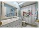 Light blue bathroom featuring a white vanity with marble countertops at 5157 Silent Loop # 214, New Port Richey, FL 34652
