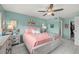 Relaxing bedroom with flamingo accents, tile floors, and modern ceiling fan at 5157 Silent Loop # 214, New Port Richey, FL 34652