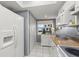 Bright kitchen featuring white appliances and cabinets and a large refrigerator at 5157 Silent Loop # 214, New Port Richey, FL 34652
