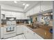 Bright kitchen featuring white appliances and cabinets and a large double basin sink at 5157 Silent Loop # 214, New Port Richey, FL 34652