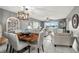Open-concept living and dining room with modern lighting and waterfront views at 5157 Silent Loop # 214, New Port Richey, FL 34652