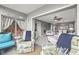 Open living area featuring a ceiling fan, and views to kitchen and sunroom at 5157 Silent Loop # 214, New Port Richey, FL 34652