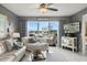 Bright living room featuring a large window with views of the marina and canal at 5157 Silent Loop # 214, New Port Richey, FL 34652