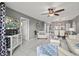 Living room with tv, white furniture, and tile floors at 5157 Silent Loop # 214, New Port Richey, FL 34652