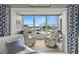 Cozy sunroom with comfortable chairs and a view of the water and boats at 5157 Silent Loop # 214, New Port Richey, FL 34652
