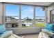 Inviting sunroom featuring comfortable seating and a picturesque view of the pool, waterway, and harbor at 5157 Silent Loop # 214, New Port Richey, FL 34652