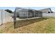 The backyard features a screened-in pool enclosure and a yard surrounded by a white fence at 518 Royal Ridge St, Valrico, FL 33594
