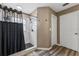 Bathroom features tiled walk-in shower with black fixtures and wood-look floors at 518 Royal Ridge St, Valrico, FL 33594