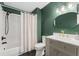 Bathroom featuring a tub/shower combo, modern vanity and stylish fixtures at 518 Royal Ridge St, Valrico, FL 33594