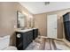 Bathroom with dual vanities, wood-look floors and modern fixtures at 518 Royal Ridge St, Valrico, FL 33594