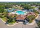 Aerial view of a community clubhouse with a resort-style pool, palm trees, and inviting lounge areas at 518 Royal Ridge St, Valrico, FL 33594