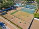Aerial view of the dog park with play equipment, picnic tables, and a green space at 518 Royal Ridge St, Valrico, FL 33594