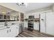 Updated kitchen with stainless steel appliances, white cabinets, and wood flooring at 518 Royal Ridge St, Valrico, FL 33594