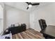 Home office featuring wood-look floors, ceiling fan, and natural light at 518 Royal Ridge St, Valrico, FL 33594