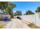 A view of the alleyway and the white vinyl privacy fence in the backyard of the property at 5324 3Rd N Ave, St Petersburg, FL 33710