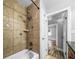 Tiled shower and tub featuring dual shower heads near a doorway and vanity at 5324 3Rd N Ave, St Petersburg, FL 33710