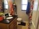 Bathroom featuring vanity with black countertop, matching mirror, and a floral shower curtain at 5324 3Rd N Ave, St Petersburg, FL 33710