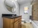 Updated bathroom featuring vanity with stone countertop and a fully tiled tub and shower enclosure at 5324 3Rd N Ave, St Petersburg, FL 33710