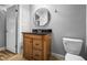 Bathroom featuring wood vanity with black countertop, round mirror, and modern fixtures at 5324 3Rd N Ave, St Petersburg, FL 33710