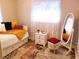 Cozy bedroom with daybed, accent rug, bedside table, full length mirror and neutral color palette at 5324 3Rd N Ave, St Petersburg, FL 33710