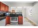 Bright kitchen featuring stainless steel appliances, wooden cabinets, and an eat-in dining area at 5324 3Rd N Ave, St Petersburg, FL 33710
