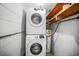 Convenient laundry room featuring a stackable washer/dryer, water heater and overhead storage at 5324 3Rd N Ave, St Petersburg, FL 33710