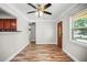 Living room showcasing wood-like flooring, base trim and a ceiling fan with attached light fixture at 5324 3Rd N Ave, St Petersburg, FL 33710