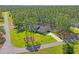 Beautiful single-Gathering home with a long driveway surrounded by a luscious green lawn and wooded area at 5458 Zamia Dr, Brooksville, FL 34604