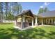 Backyard featuring a covered patio with hot tub and outdoor seating for entertaining or relaxation at 5458 Zamia Dr, Brooksville, FL 34604