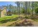 A backyard featuring an outbuilding, shady trees, and a hot tub area at 5458 Zamia Dr, Brooksville, FL 34604