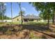 A wide view of the home's spacious and private backyard with mature trees at 5458 Zamia Dr, Brooksville, FL 34604