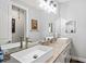 Modern bathroom featuring dual sinks, granite countertops, and stylish lighting at 5458 Zamia Dr, Brooksville, FL 34604