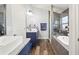Well-lit bathroom featuring granite counters, dual sinks, a tub, and separate shower with glass doors at 5458 Zamia Dr, Brooksville, FL 34604