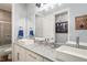 Modern bathroom featuring double sinks, granite counters, and a shower/bath at 5458 Zamia Dr, Brooksville, FL 34604