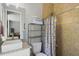 The bathroom is equipped with a toilet and a sink with a banana themed shower at 5458 Zamia Dr, Brooksville, FL 34604