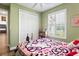 Whimsical bedroom with a large window, featuring a Hello Kitty themed bedspread and decor at 5458 Zamia Dr, Brooksville, FL 34604