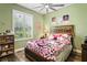 Charming Hello Kitty themed bedroom with bright natural light and a decorative ceiling fan at 5458 Zamia Dr, Brooksville, FL 34604