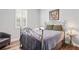 Stylish bedroom featuring an iron bed frame, hardwood floors, and natural lighting at 5458 Zamia Dr, Brooksville, FL 34604