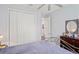 Bright bedroom featuring a metal bed frame and double door closet at 5458 Zamia Dr, Brooksville, FL 34604