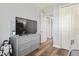 Cozy bedroom featuring a dresser, large TV, and a decorative Stormtrooper figure at 5458 Zamia Dr, Brooksville, FL 34604