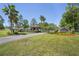 Gated entrance to Royal Palm Estates showing manicured landscaping and palm trees at 5458 Zamia Dr, Brooksville, FL 34604