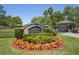 Royal Palm Estates entrance featuring a stone archway and lush landscaping at 5458 Zamia Dr, Brooksville, FL 34604