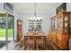 Traditional dining room with hardwood floors, natural light, and classic wooden furniture at 5458 Zamia Dr, Brooksville, FL 34604