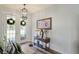 Inviting entryway featuring hardwood floors, stylish lighting, and a charming side table at 5458 Zamia Dr, Brooksville, FL 34604