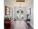 Inviting entryway featuring hardwood floors, stylish lighting, and charming decor at 5458 Zamia Dr, Brooksville, FL 34604