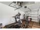 Home gym with a treadmill and weight equipment in a converted garage with light colored door at 5458 Zamia Dr, Brooksville, FL 34604