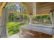 Hot tub inside covered pavilion in a spacious backyard with shed and bordered by trees at 5458 Zamia Dr, Brooksville, FL 34604