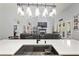 Bright kitchen island with stainless steel sink overlooks the living room with fireplace at 5458 Zamia Dr, Brooksville, FL 34604