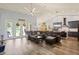 Bright living room featuring an open-concept design with hardwood floors, a kitchen, and comfortable seating at 5458 Zamia Dr, Brooksville, FL 34604