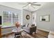 Bright living room featuring hardwood floors and a window seat overlooking the backyard at 5458 Zamia Dr, Brooksville, FL 34604